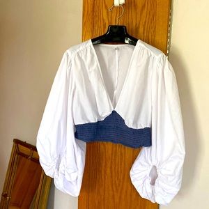 Dramatic midriff blouse with Amazing sleeves with elastic closure . Denim detail